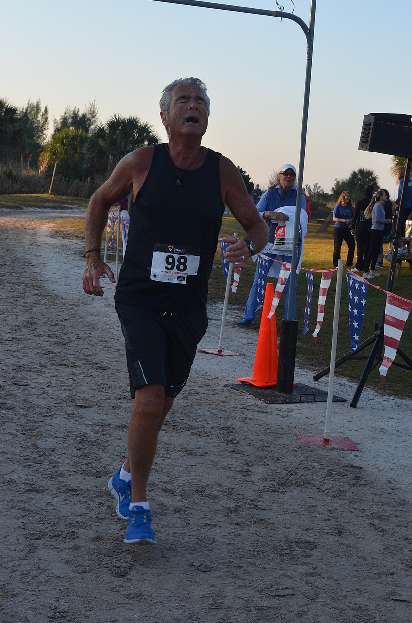 Denis Pearl, 70, finishes the 5K with a time of 28:42.
