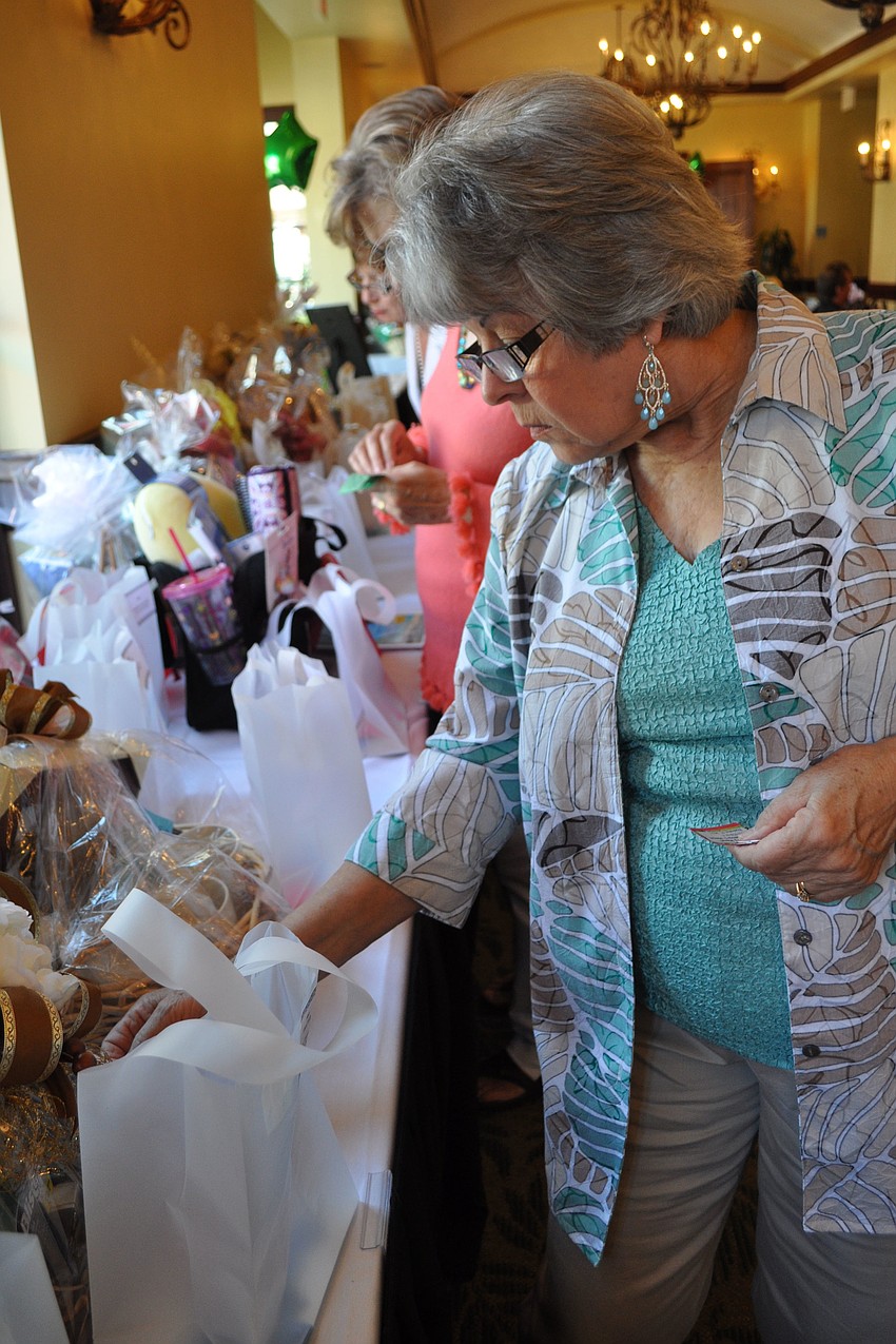 Patricia Mascari checked out the auction items.