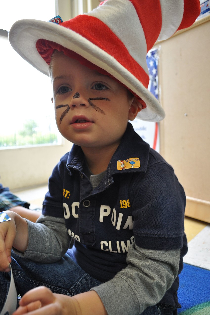 Caden Zabawski, 3, wears a real Dr. Seuss hat while listening to a story.