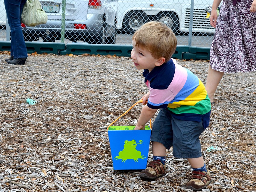 Paul Dillon Helton, Jr. places an egg in his basket.