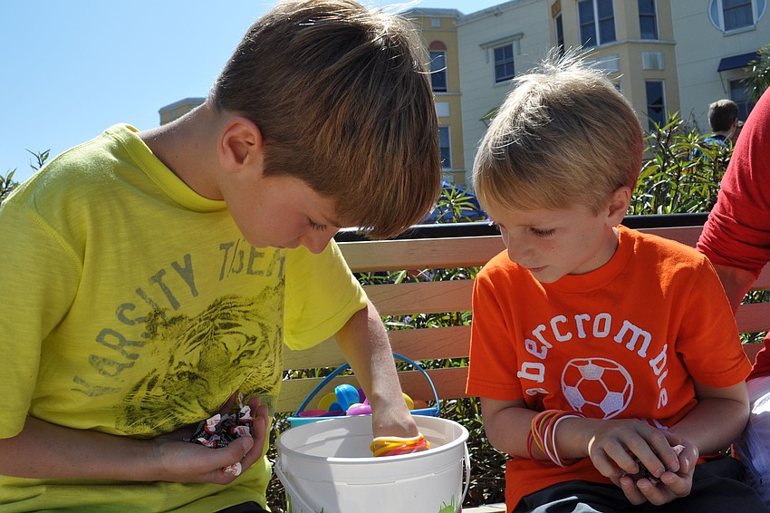 Evan and Oliver Hoover broke open their eggs to recover Tootsie Rolls.