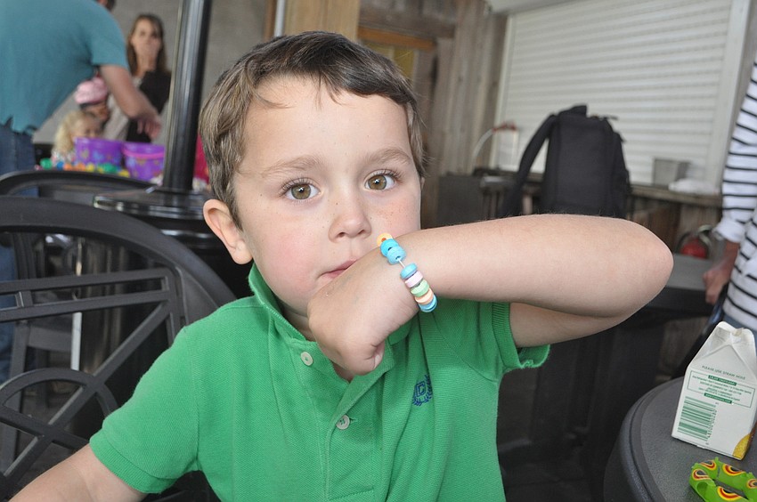 Dutton Yost, 4, enjoys a candy bracelet
