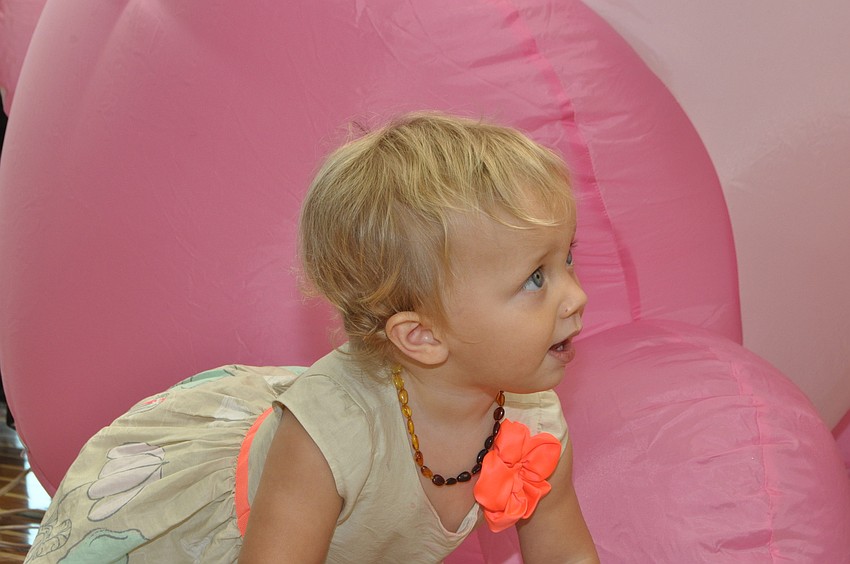 Navah Cassagnol, 1, crawls around the inflatable bunny.