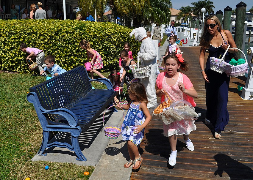 Children ran around the back of Bird Key Yacht Club picking up Easter eggs Sunday afternoon.
