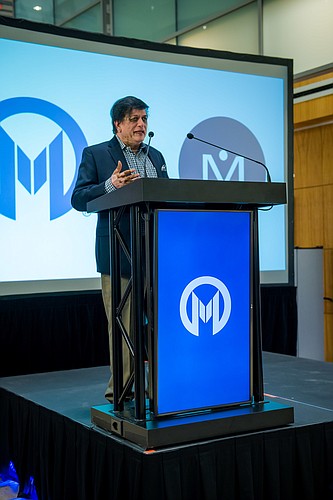 Investor Kiran Patel speaks at an event held to celebrate Morphogenesis Inc.&#39;s successful application to conduct human clinical trials of its skin cancer vaccine. Courtesy photo.