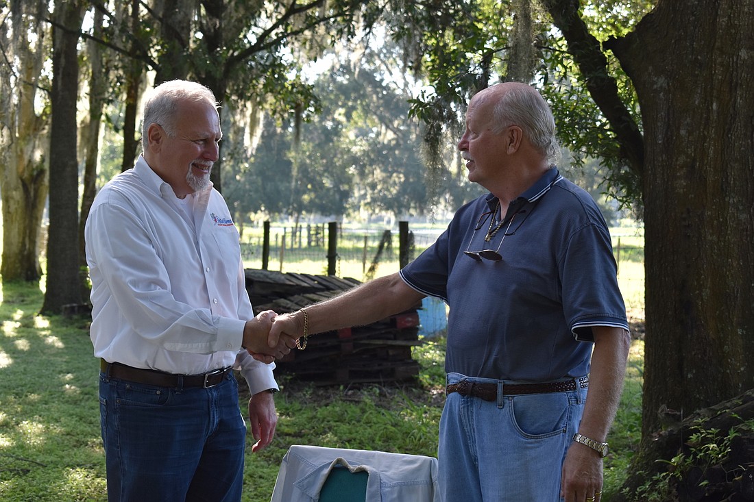 WishÂ Farms owner Gary Wishnatzki, left, and Joe Kuhn, seller of the 36-acre property along Interstate 4 that will be the new home of Wish Farms. Courtesy photo.