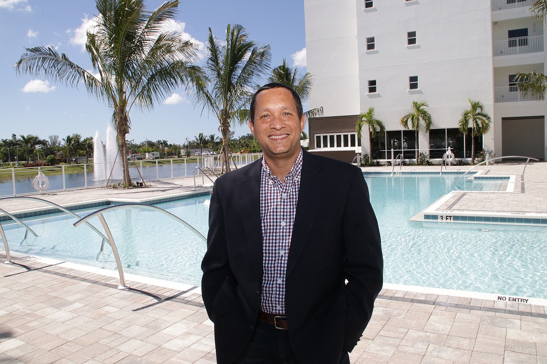 Colin Marshall, president of Quadrum Global&#39;s Senior Living Management Division, is poolside at one of three pools at Amavida, which is scheduled to open in December. JimJett.com photo