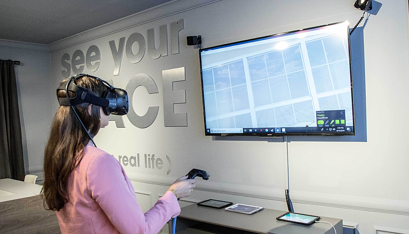 A Macy&#39;s customer uses Marxent&#39;s VR technology to evaluate different furniture arrangements. Courtesy photo.
