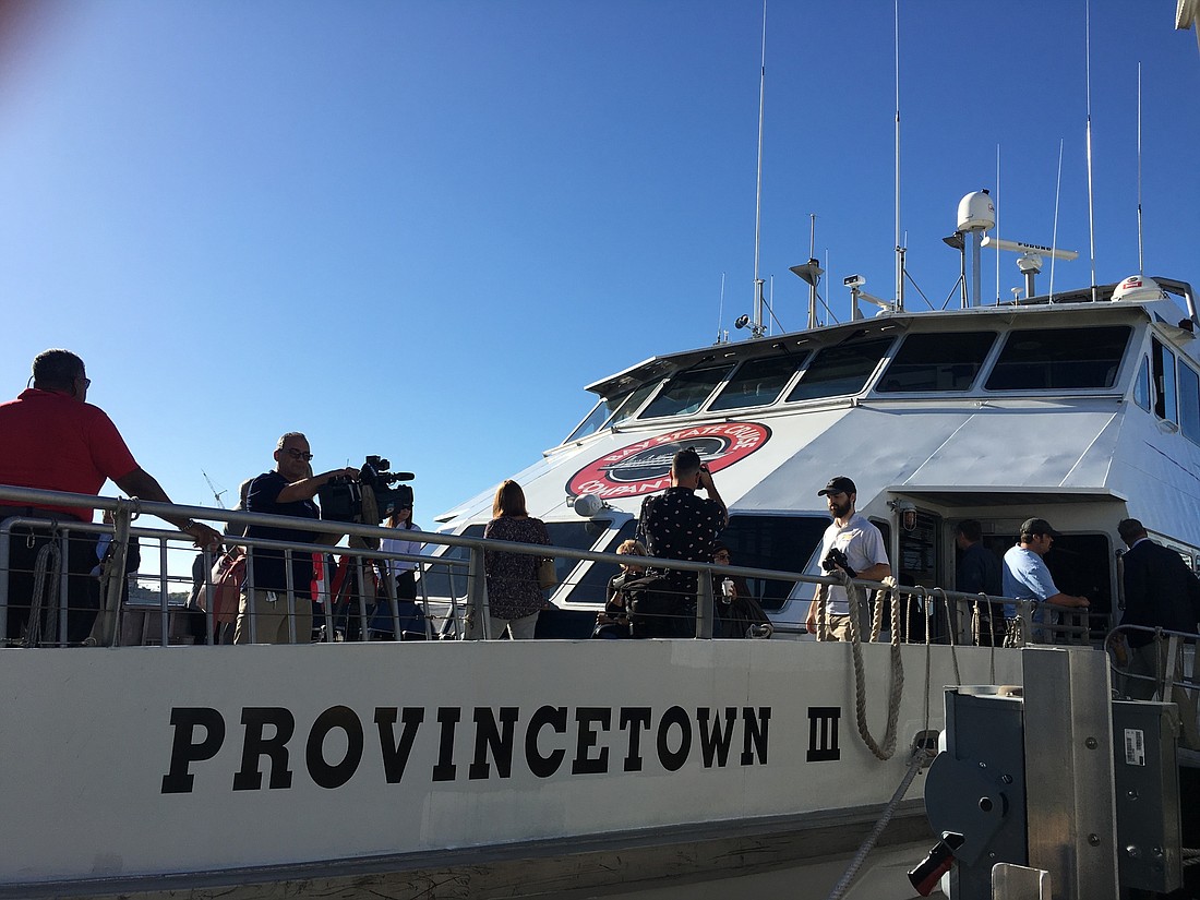 Officials and members of the media gather on the deck of the Cross-Bay Ferry for the the maiden voyage of the service&#39;s 2018-19 season. Courtesy photo.