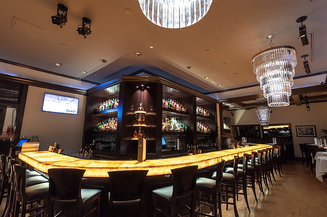 A lighted bar top made of onyx is the centerpiece of the renovation of Truluck&#39;s in the Fifth Avenue South district of Naples.