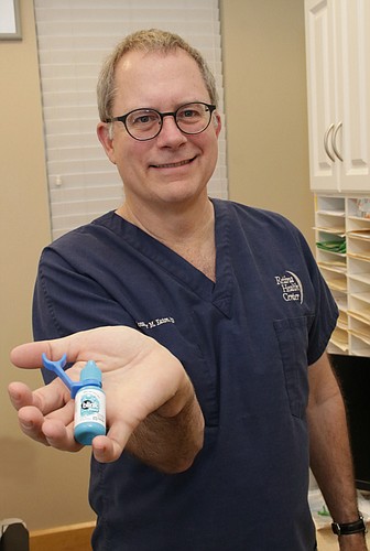 Dr. Alexander Eaton of Retina Health Center and his XactDrop eyedrop device. JimJett.com photo