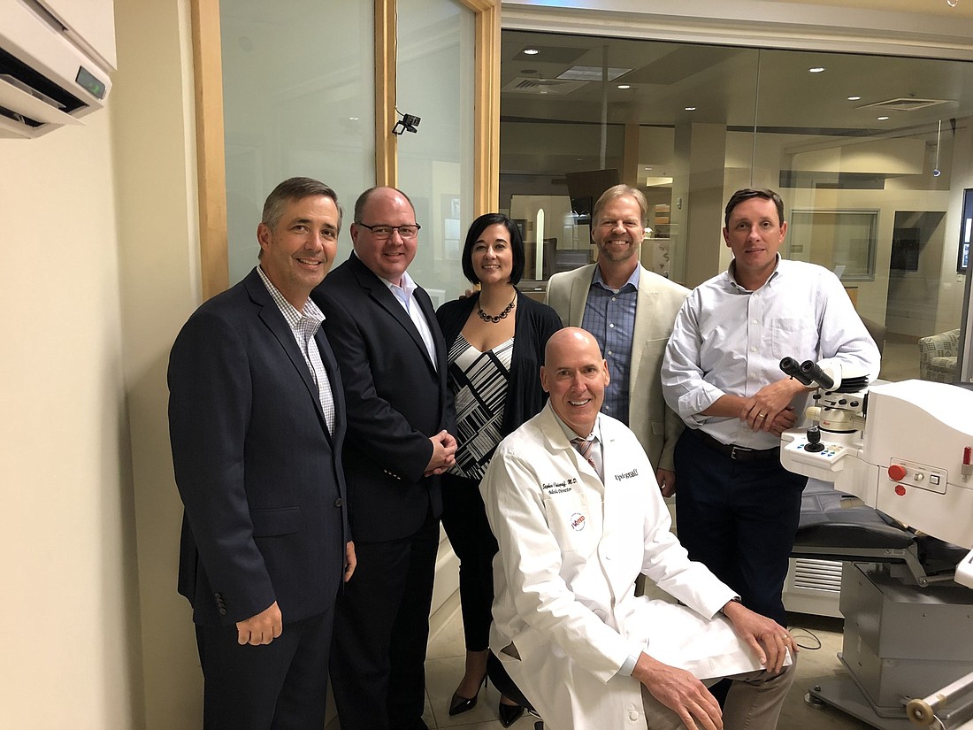 From left: John Swencki, Rod Roeser, Erin Pulsfort and Philip Isham of Eye Health America; and Patrick Maguire of Updegraff Laser Vision. Seated: Dr. Stephen Updegraff.