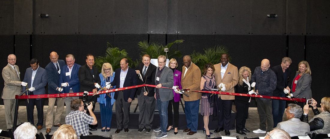 Courtesy, Cliff Roles. Officials cut the ribbon at a ceremony marking the opening of the Studio Labs Post-Production facility on the Ringling College campus.
