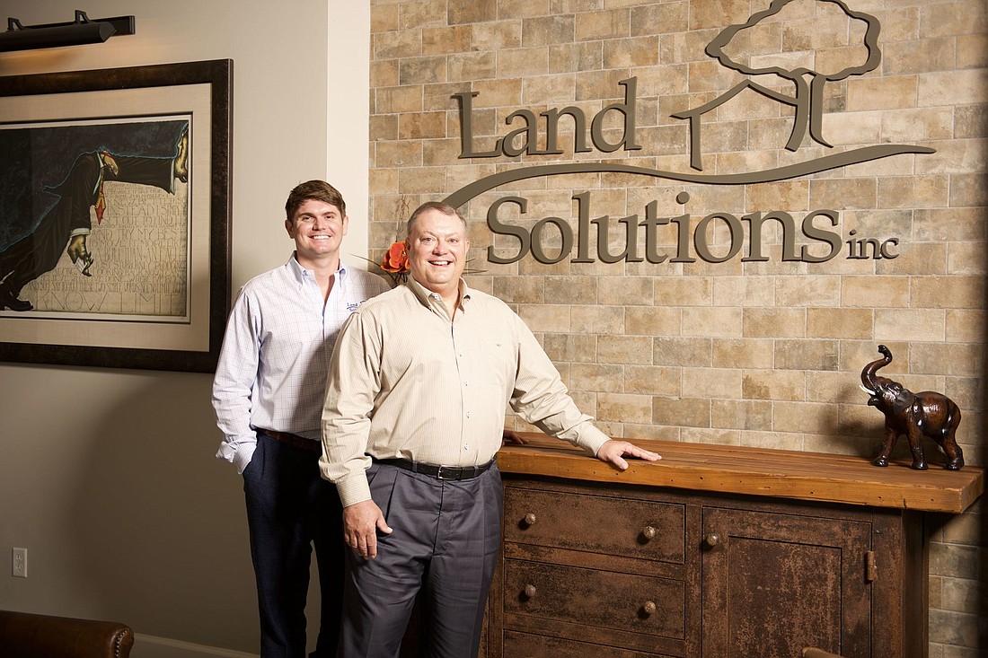 COURTESY PHOTO â€” Justin Thibaut, left, has been named COO of Fort Myers-based Land Solutions Inc., which his father, Randy Thibaut, right, founded in 1999.