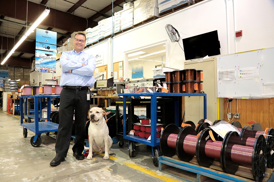 Pelican Wire President Ted Bill, with the help of company mascot Alabama, helped guide the company from family ownership to an ESOP after the death of his father, founder Larry, in 2008. Stefania Pifferi photo