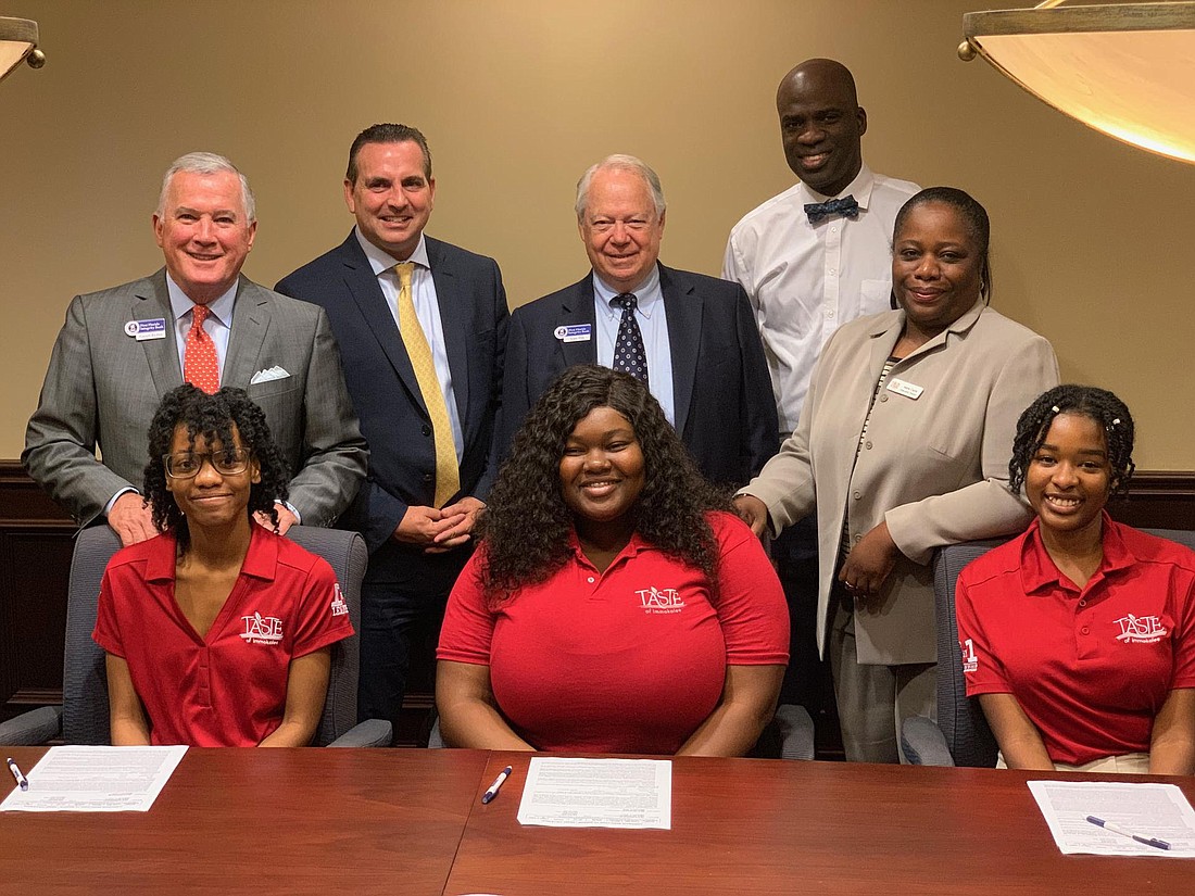 Students and leadership of Taste of Immokalee and First Florida Integrity Bank ink a deal to finance the B-corp&#39;s expansion into more than 200 Publix stores statewide. Courtesy Taste of Immokalee.
