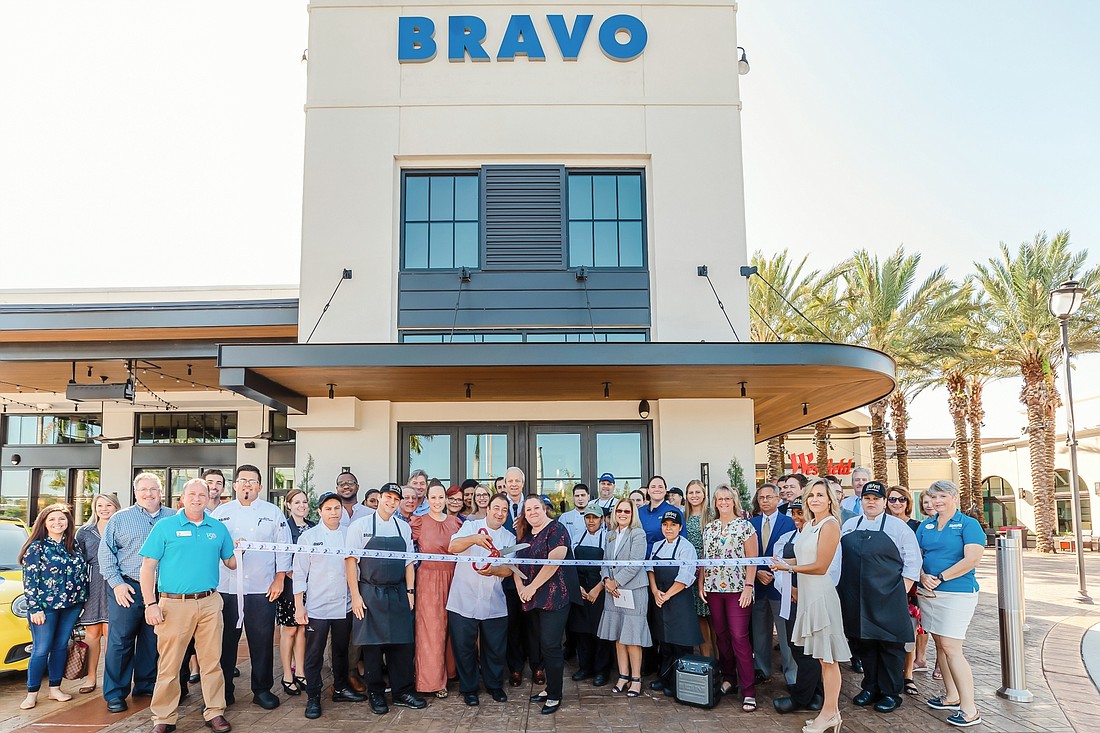 Courtesy, Lotus Eyes Photography. Brad Blum, chairman and CEO of FoodFirst Global Restaurants, joined other officials and staff for the ribbon cutting of the new restaurant concept Bravo Italian Mediterranean.