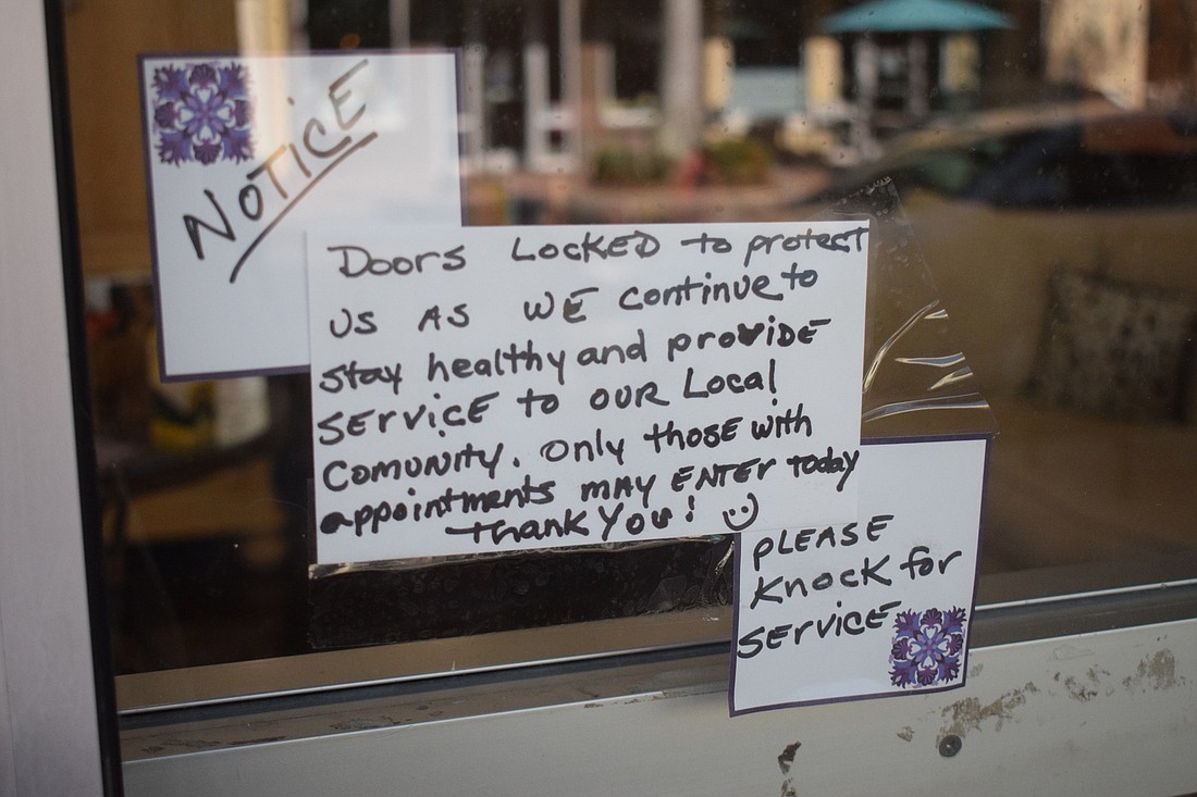 File. Business owners have a variety of opinions on when to reopen.