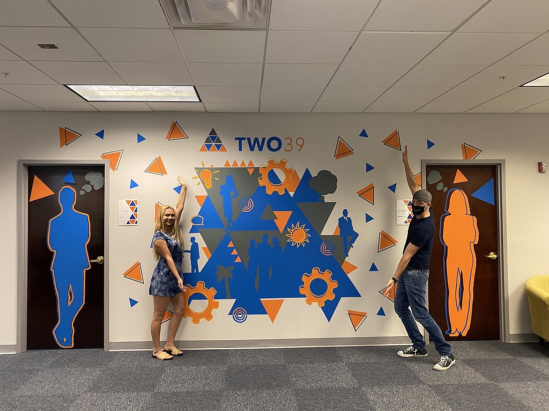 Courtesy. Two 39 Group includes a venture capital arm and cowork space. Pictured here is Taylor Thompson, a Florida Gulf Coast University art and entrepreneurship student and Alex Allen.
