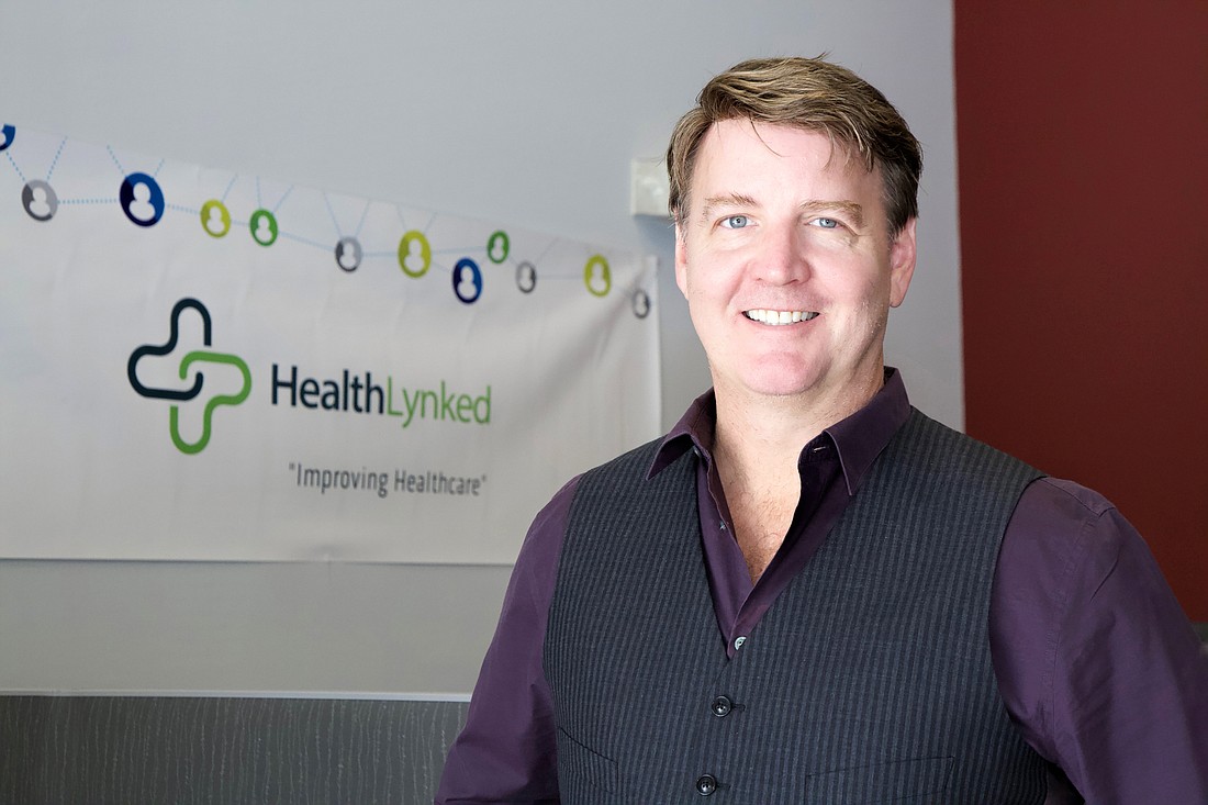 File. HealthLynked Chairman and CEO Dr. Michael Dent says the firmâ€™s successful COVID-19 tracking app gave it global notoriety.