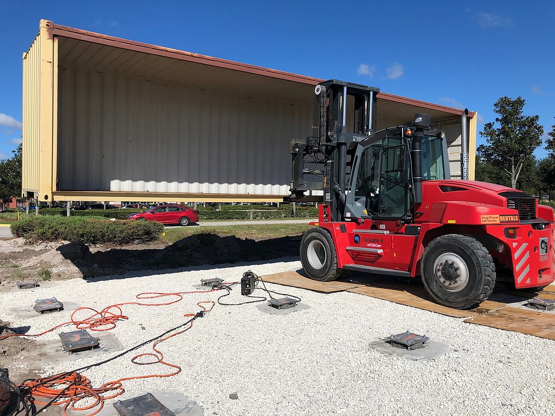 Courtesy. Construction crews have begun installing the first set of containers that will make up KRATE, a $15 million container park at the Grove at Wesley Chapel shopping center.