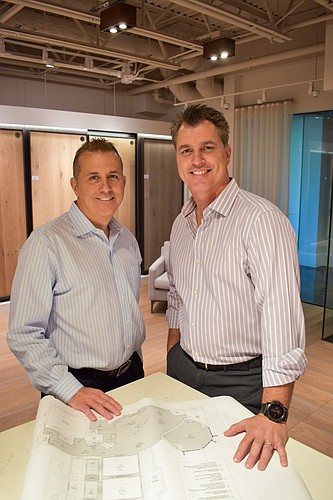 Courtesy. Travis Brown, left, poses with Steve Karterouliotis, right, after Brown was appointed shareholder of Steveâ€™s Supreme Flooring and Unique Wood Floor Co., both Naples-based companies.