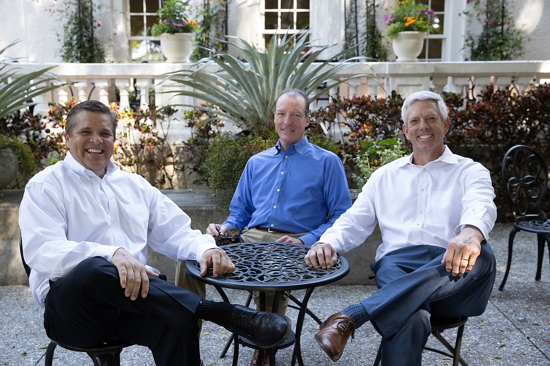 Courtesy. Tommy Kochis, Rob Brown and Darren Howard, are shareholders at Sarasota-based Atlas Insurance, founded in 1953. (Photo taken at Selby Gardens in Sarasota.)