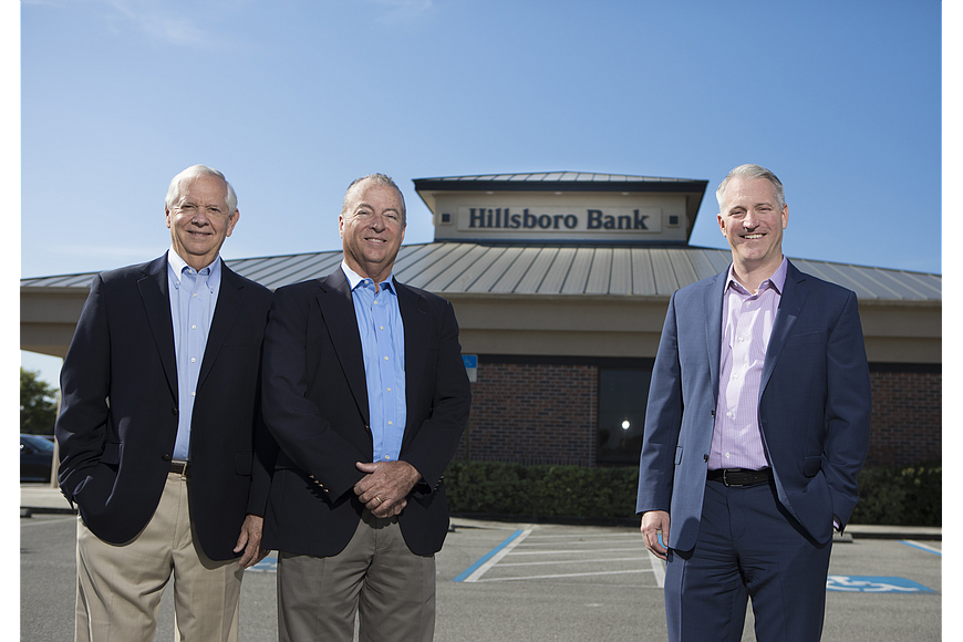 File. Bank of Tampa executives Bill West, left, and Corey Neil, far right, with Hillsboro Bank CEO Mike Ward. The two banks completed their merger on Oct. 1.