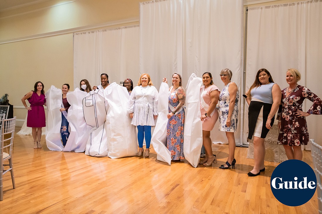 Courtesy. Hillsborough County first responders and frontline health care workers with wedding dresses they received from The Regent, an event space in Riverview.