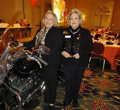 McMorrow (right) was named NEFAR's Realtor of the Year at last month's annual meeting and she and Kaiser posed on NEFAR President Dane Leslie's motorcycle.