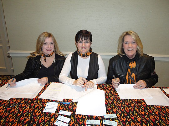 Carolyn Yow, Debbie Dermody and Wendy Echols of NEFAR check people in at the meeting.