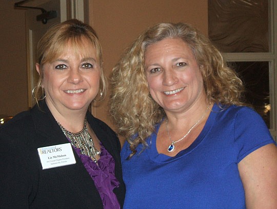 The Jacksonville chapter of the Women's Council of Realtors held its monthly meeting at San Jose Country Club to hear CPA Hank Watson (right), who's here with WCR President Liz McMahan of Watson Realty.