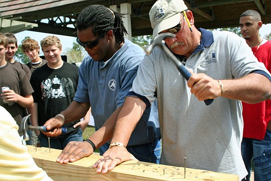 Keith Ward, NEFBA's training vice president,  participates in the annual nail-driving competition for carpentry apprentices.