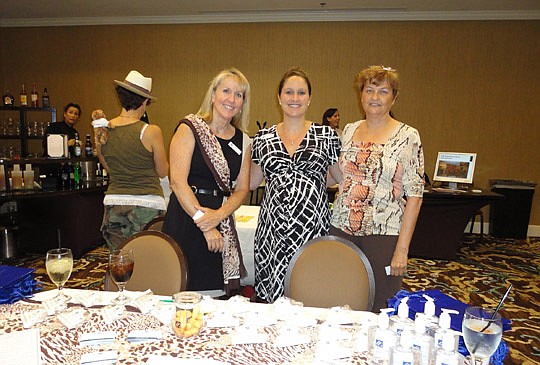 In this booth, Mary Mansker, Melissa Meide Matthews and Marte Langston of Standard Pacific Homes had a lot of giveaways.