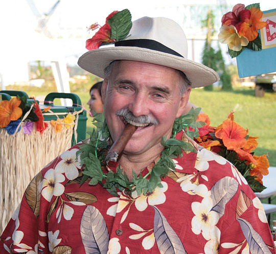 Larry Wittmer enjoys life to the fullest, and it shows. Here he puts all his effort into having a good time at the Builders Care food booth at the NEFBA 2010 Charity Gala. Funds from the Gala help support Builders Care projects.