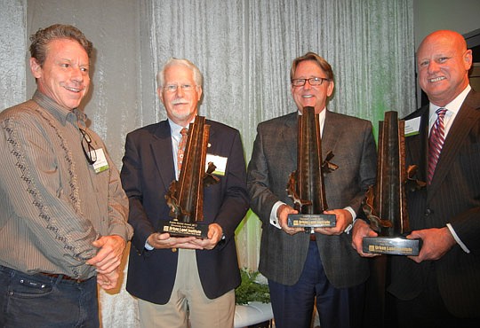 David Ponsler (left) of Ponsler Metal Design was commissioned by Urban Land Institute North Florida to design the awards presented Thursday evening to the winners of the inaugural ULI Awards for Excellence. From left, Wayne Wood represented the Rivers...
