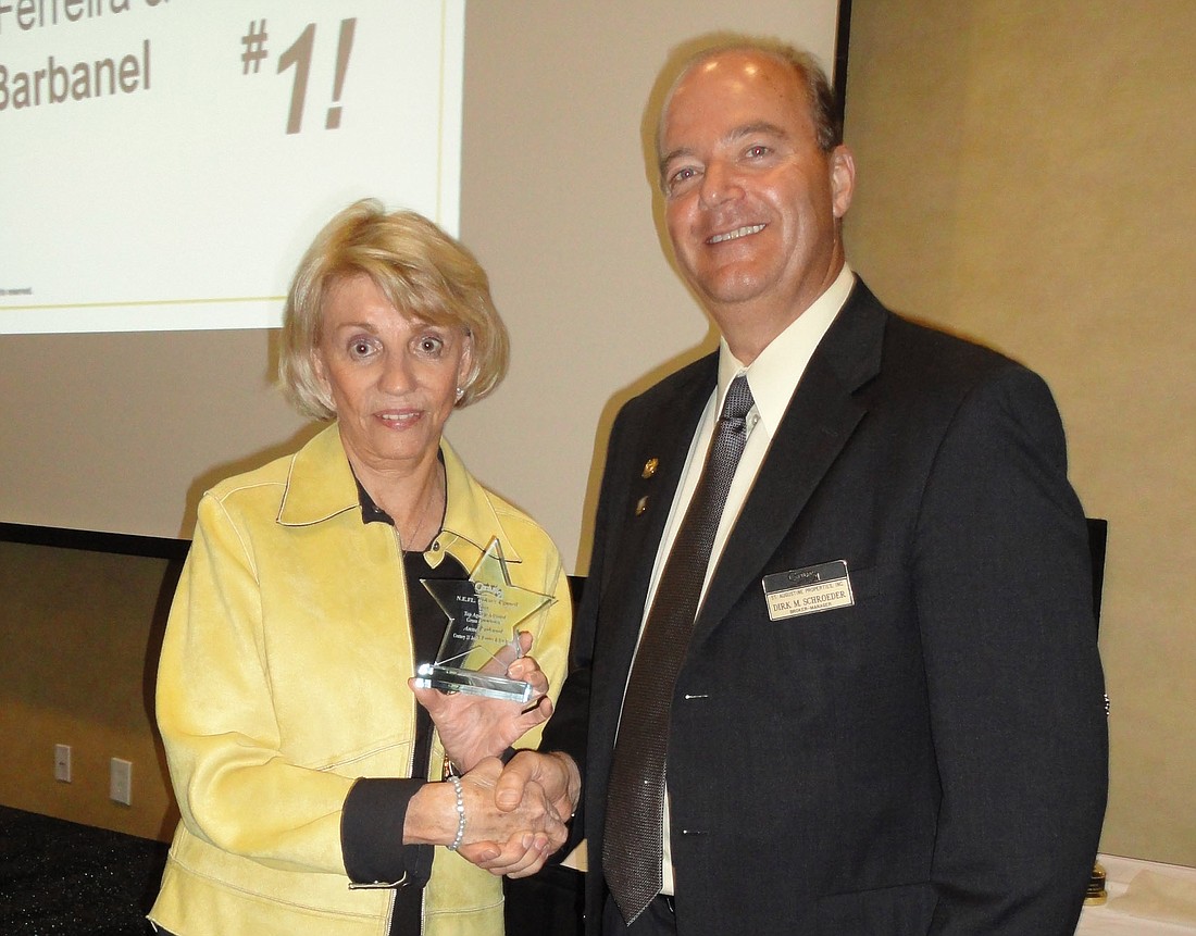 Ann Barbanel of John T. Ferreira &amp; Son receives the Top Agent in Adjusted Gross Commission award from Broker's Council President Dirk Schroeder.