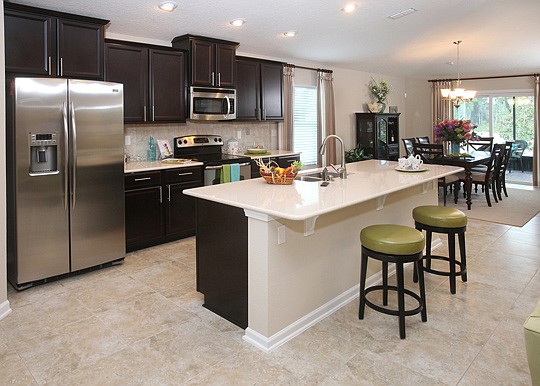 The kitchen opens into the dinning room and main living space in the Longwood Model at Azalea Ridge.