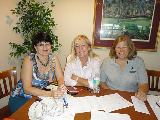 Debbie Dermody of NEFAR, Kathy Karr-Garcia of The Beaches Realty Group and Brenda Carmine of ACS Mortgage checked players in.