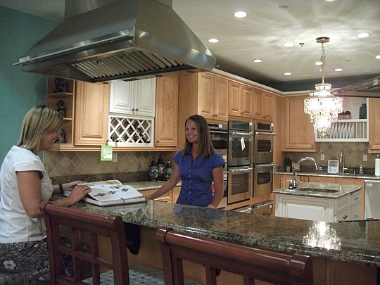 MandyÂ BoutonÂ (right), builder outside sales at Ferguson, enjoys working with customers to select the perfect lighting fixtures, bathroom fixtures and kitchen appliances for new construction and remodeling projects.