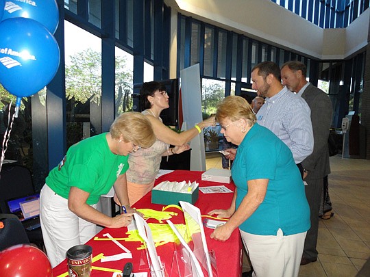 Debbie Dermody and Celeta McClamma checking guests in to the Realtor Builder Tradeshow.