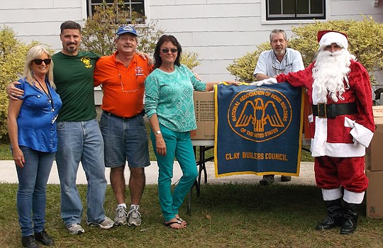 The Clay Builders Council Board of Directors helped Santa at the Christmas food basket giveaway. From left, treasurer Trish Kilosky, Council chair Michael BourrÃ©, secretary Mike Dallas, vice chair Angie Claxton-Smith and CBC Board member Tim Gardner.