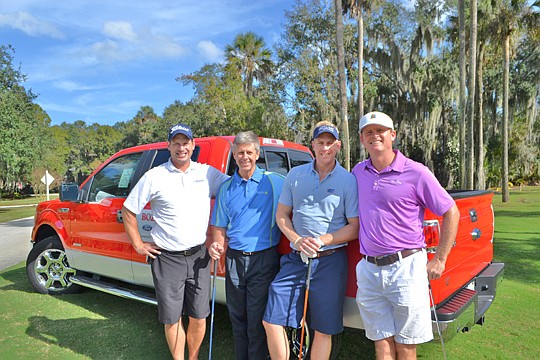 Trevor Rosendahl, 5 Star Outdoor Designs; Michael Lenahen, Aurora Custom Homes; Paul Davison, 5 Star Outdoor Designs; and William Rushing, Rushing Construction beside the truck donated by Bozard Ford and insurance provided by Designers &amp; Builders ...
