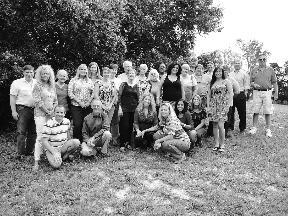 Some of the Magnolia Properties staff: (front row, kneeling) Anthony Marotta, Lin Abercrombie, broker/owner Eileen Blocker, Ronda Densford, Laila Salameh and Amy Schrader, and (standing)  Ken Goodwin, Laura Gage, Connie McElmurray, Teresa Scoggins, Ce...