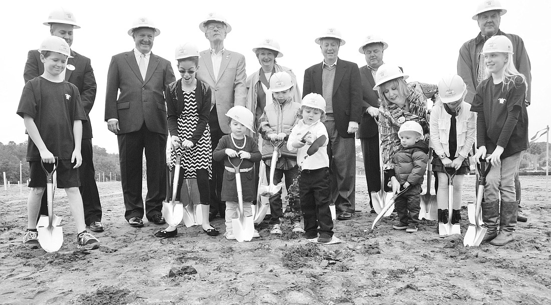 Children of Atlantic Beach Country Club members turn the first shovels of dirt to mark the groundbreaking of the community last month while members of the development team and community leaders await their turn. (Front row, from left) Tucker Ferguson,...