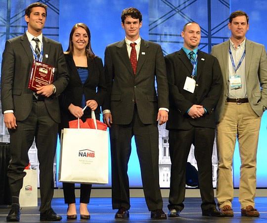 From left, University of North Florida students Alex Hepler (team captain), Jeanette Saliba, Sam Giordan and Scott Sullivan with David Hacker (NEFBA member and team coach) take center stage at the International Builders Show. The UNF team finished sec...