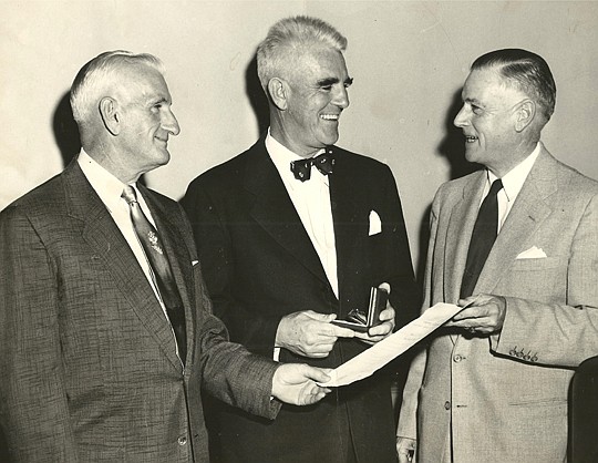 Cecil Wainwright (left), NEFBA president 1954, and Joseph Davin, NEFBA's first president in 1944 and 1945, discuss home sales with an area Realtor in this 1950s meeting.