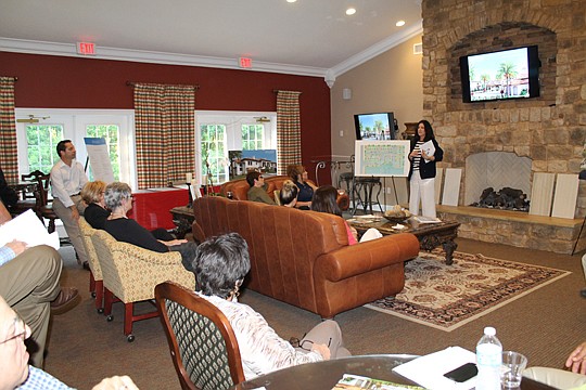 ReMax WaterMarke's Michelle Mousin, director of sales, presents the site plan for Portofino, a 23-unit townhouse development near Queen's Harbor Yacht and Country Club.