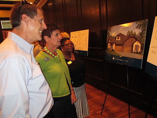 Gary Harlow, Watson Realty; Judy Hicks, Re/Max Coastal; and Faye Parker, Watson Realty, look at some of the model villas at the new Monetvilla project in Bartram Park. Standard Pacific Homes held a preview event May 19 at Maggiano's in the St. Johns T...