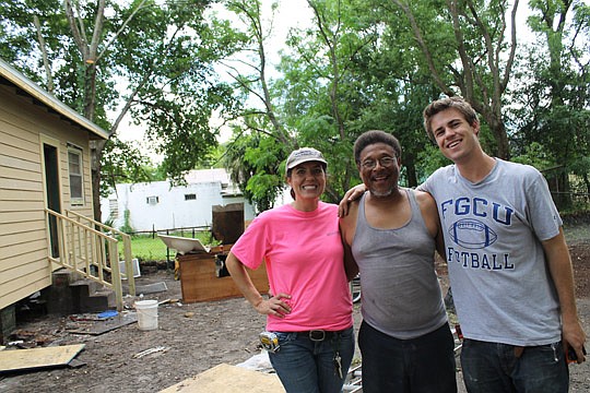 Candice Aery, project administrator for LandSouth Construction, homeowner Gerald DeBardelaben and LandSouth assistant superintendent Tyler Edenfield in the backyard of the home where DeBardelaben lives with his 2-year-old granddaughter. For this year'...